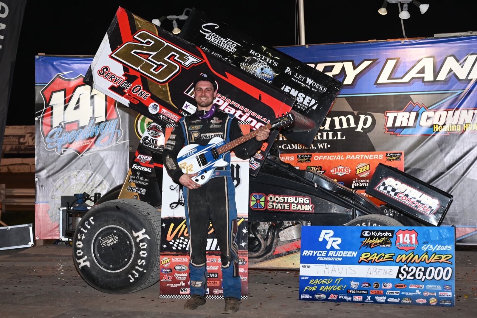 Travis Arenz in victory lane with the Rayce Rudeen Foundation guitar at 141 Speedway, 2025
